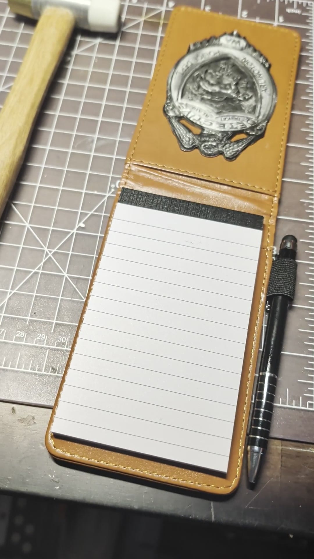 The completed detective notebook and badge shown in the video.