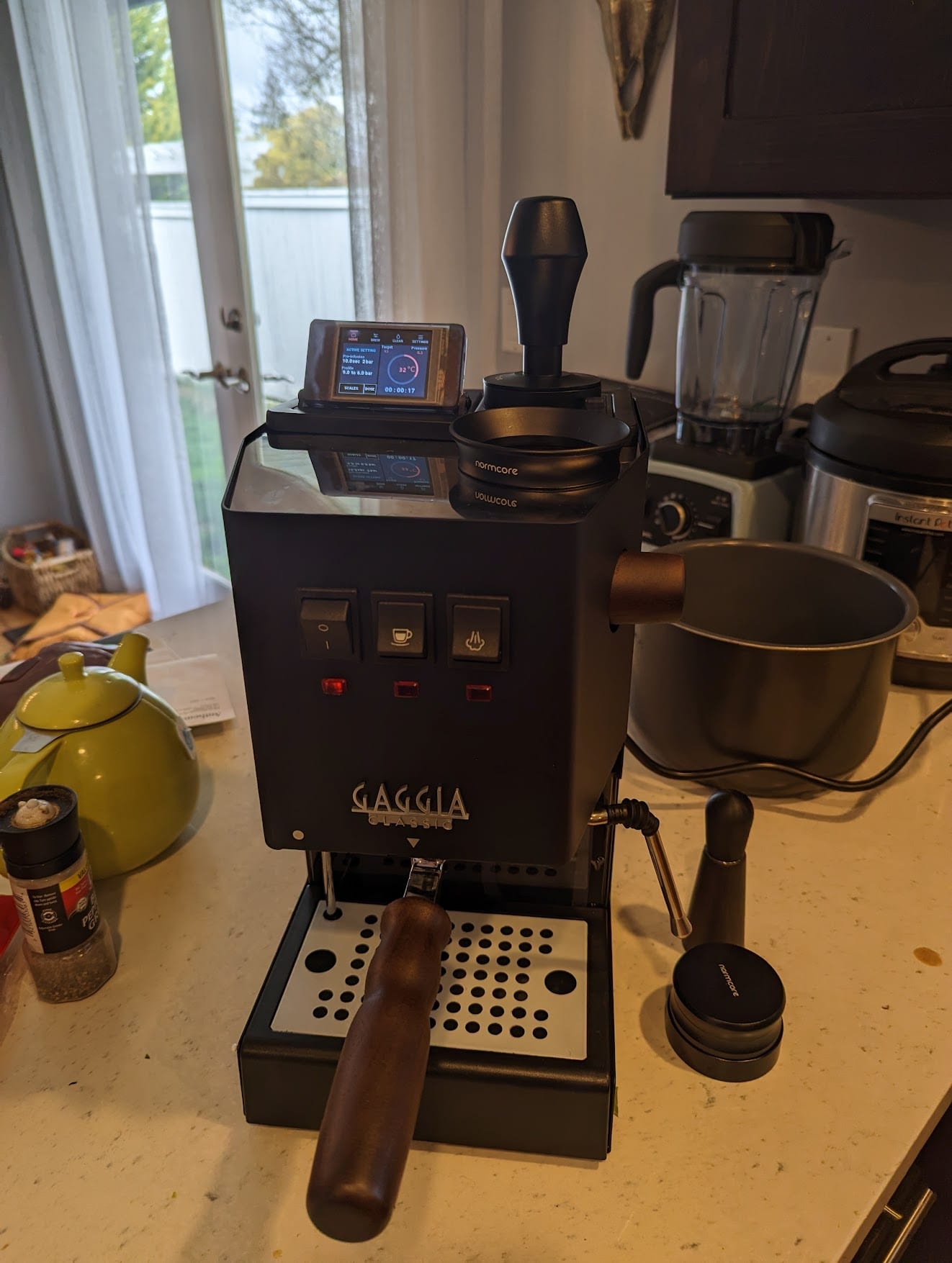 A black Gaggia Classic espresso machine with a small control display in a translucent resin-printed enclosure mounted on top.