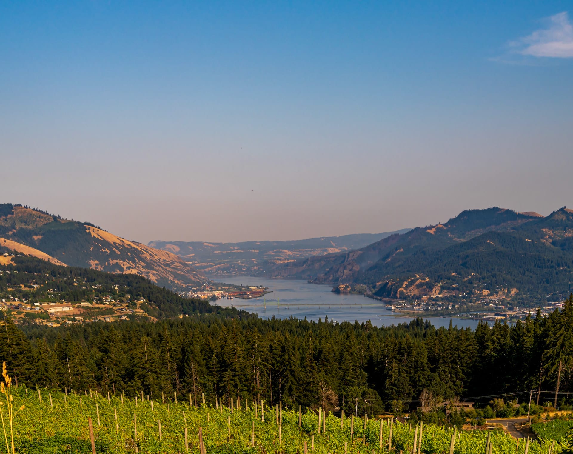 A wide panorama of the river winding between brown hills.