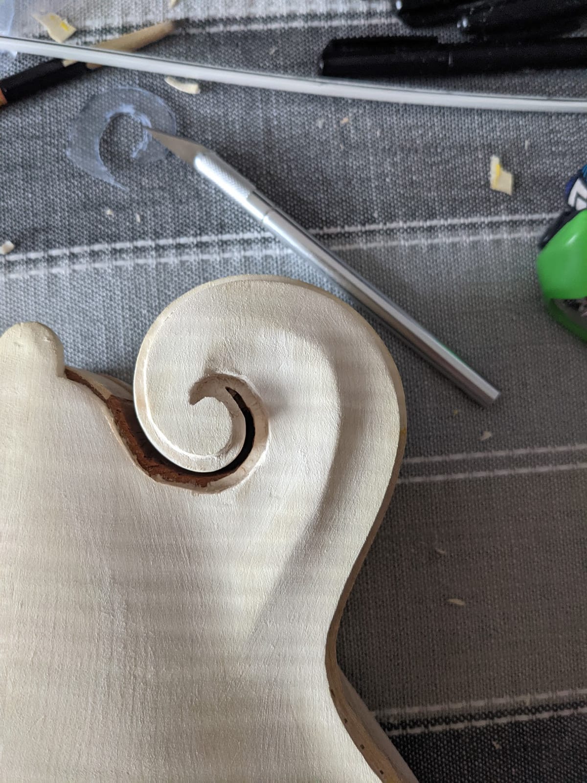 The scroll with its channel cut by hand, the ramp up to the point left proud.