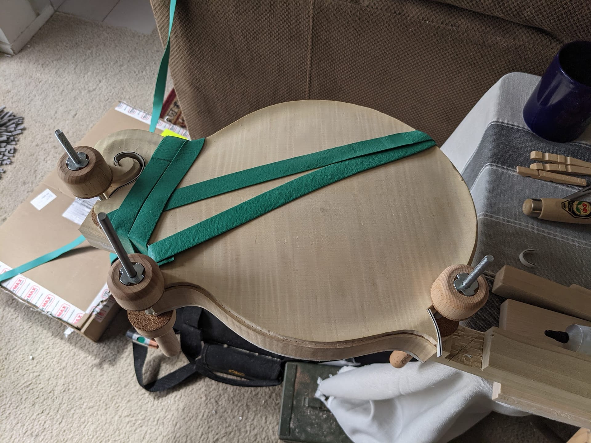 The body strapped down with wide green rubber bands and spool clamps while the front binding sets.